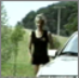 A blonde girl pees and then later has a runny shit on the roadside after pulling over in her car.